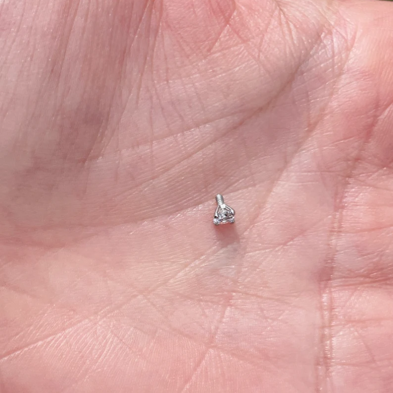 Close-up of 5mm natural diamond in 14K gold dermal anchor stud, fine body jewelry
