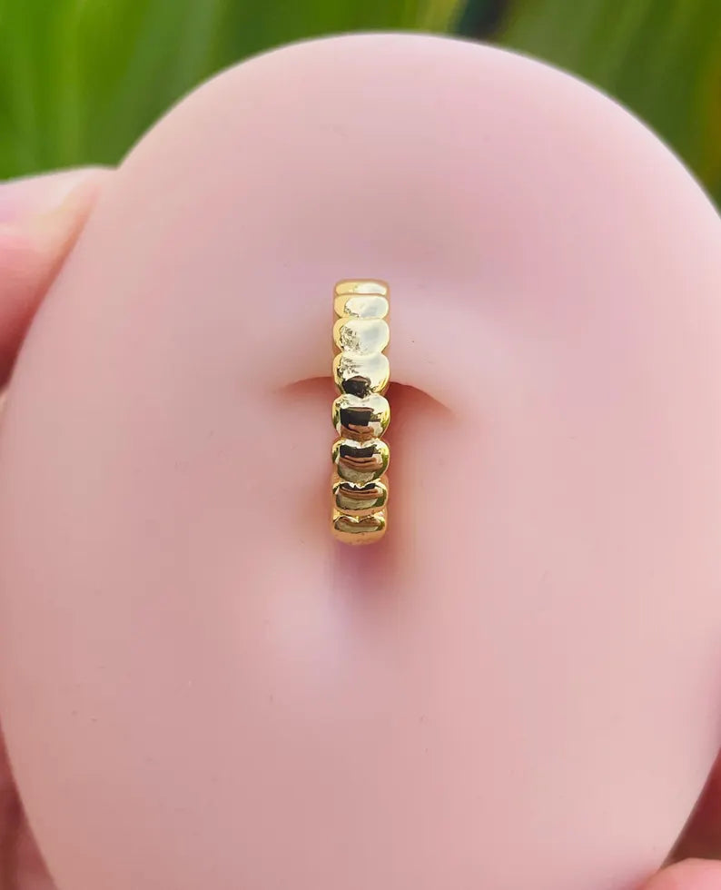 14K gold belly button clicker ring with hearts shown in navel piercing