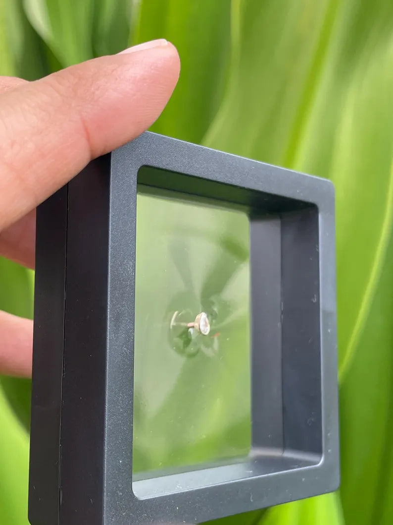 Side profile of 14K solid gold dermal top featuring 5mm pear shape natural diamond