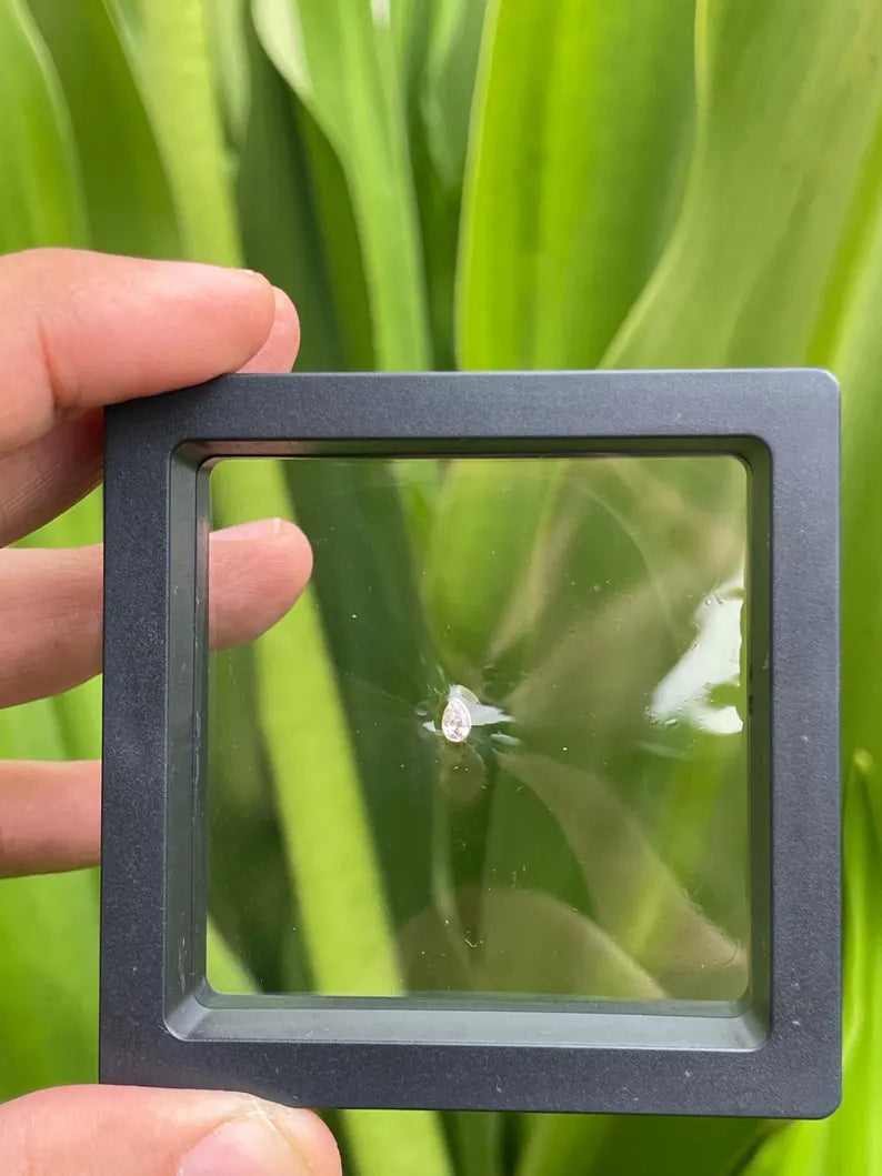 Front view of 14K gold dermal top with pear shape natural diamond bezel setting